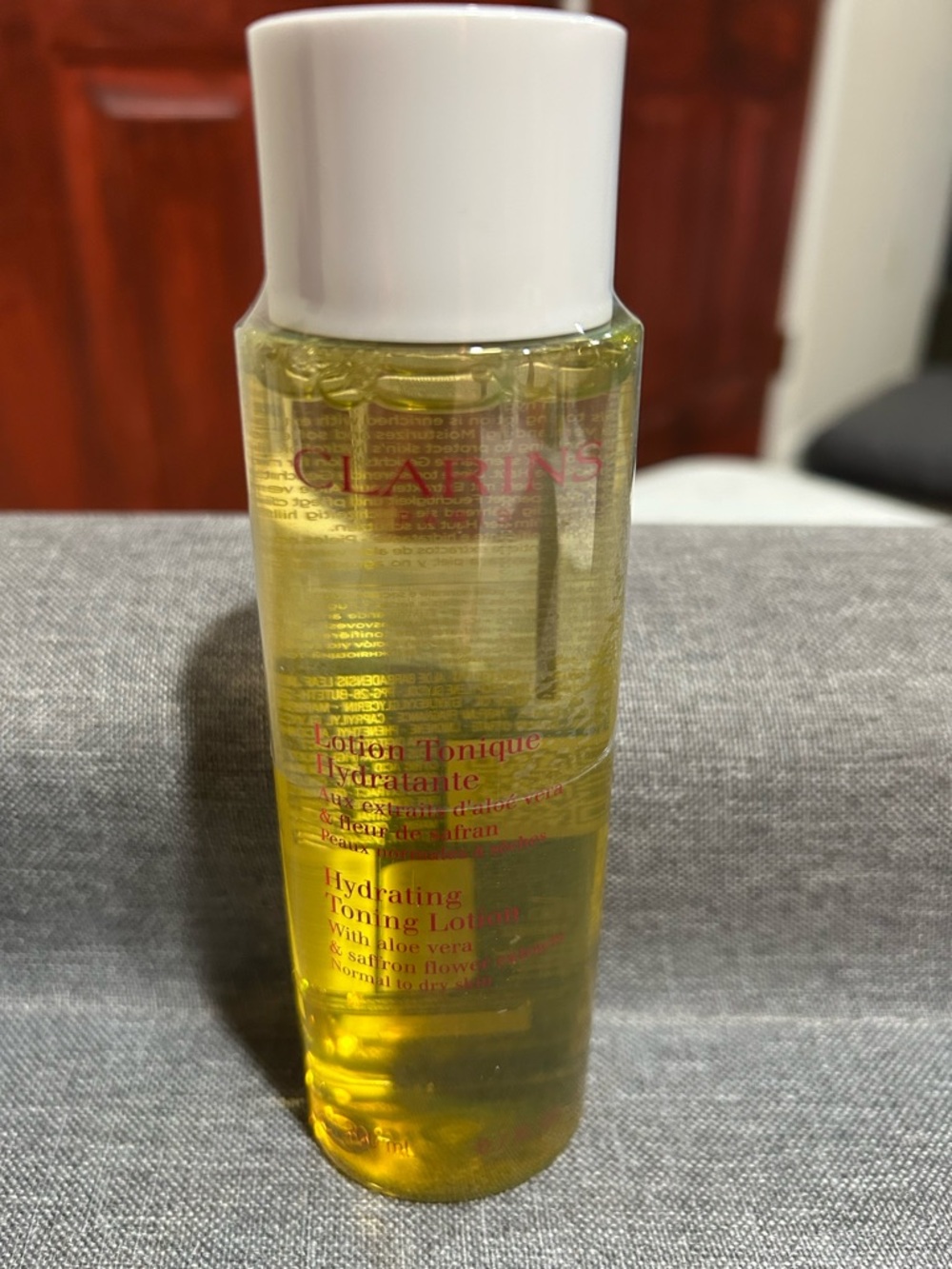 Clarins Hydrating Toning Lotion - Yellow Liquid with White Cap